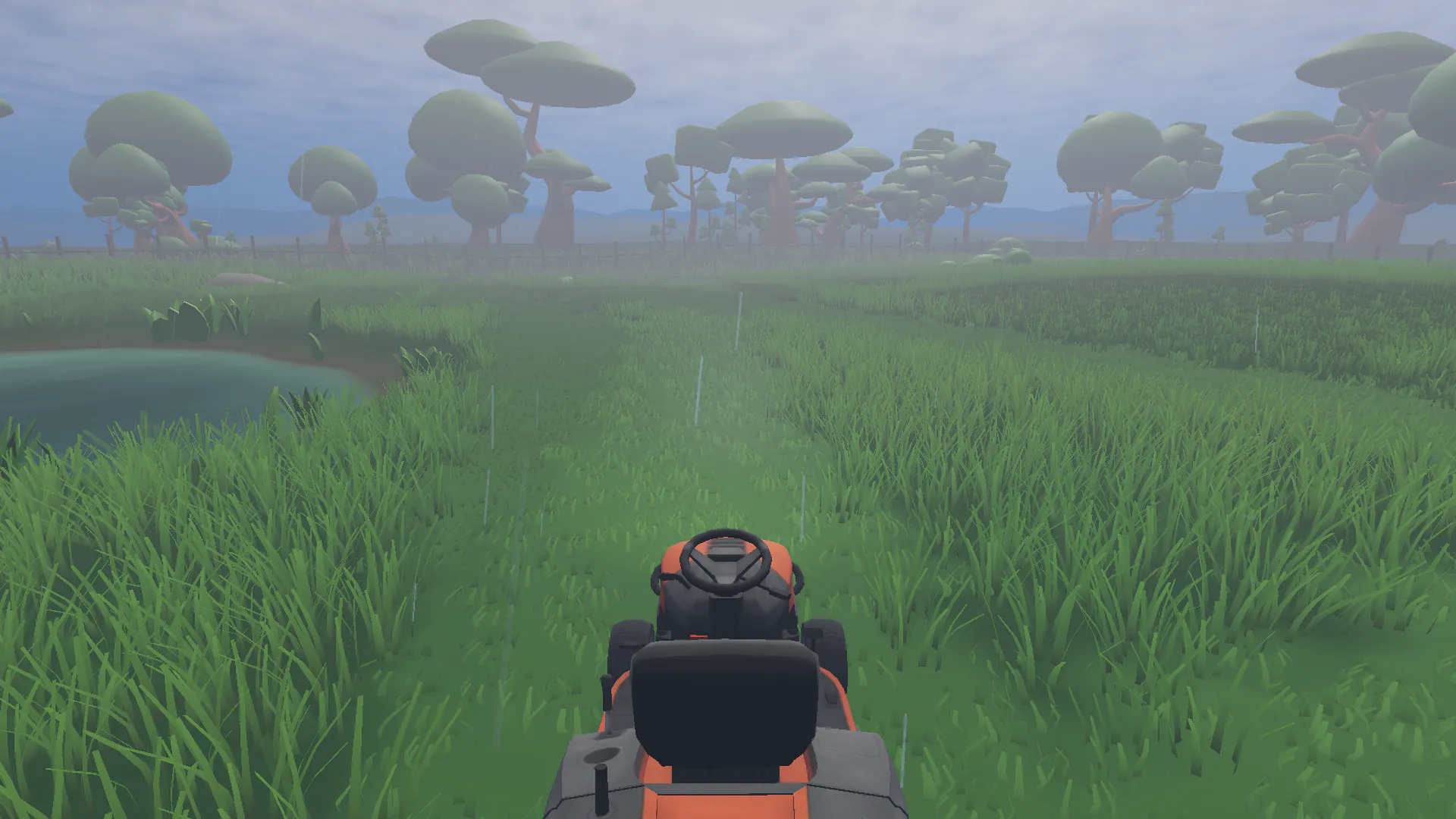 Riding mower in tall grass during light rain, with a pond and misty trees ahead